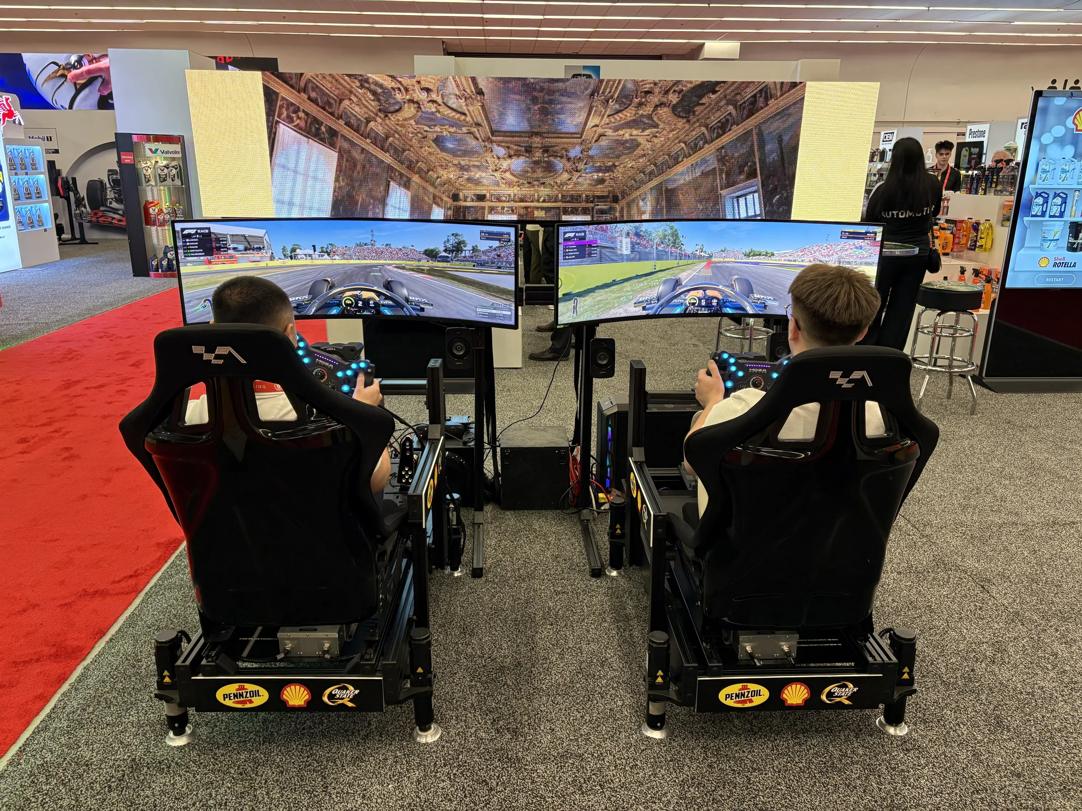 Guest driving a Pennzoil-branded Formula simulator